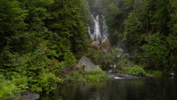 Waterfalls flowing into a calm pond desktop wallpapers